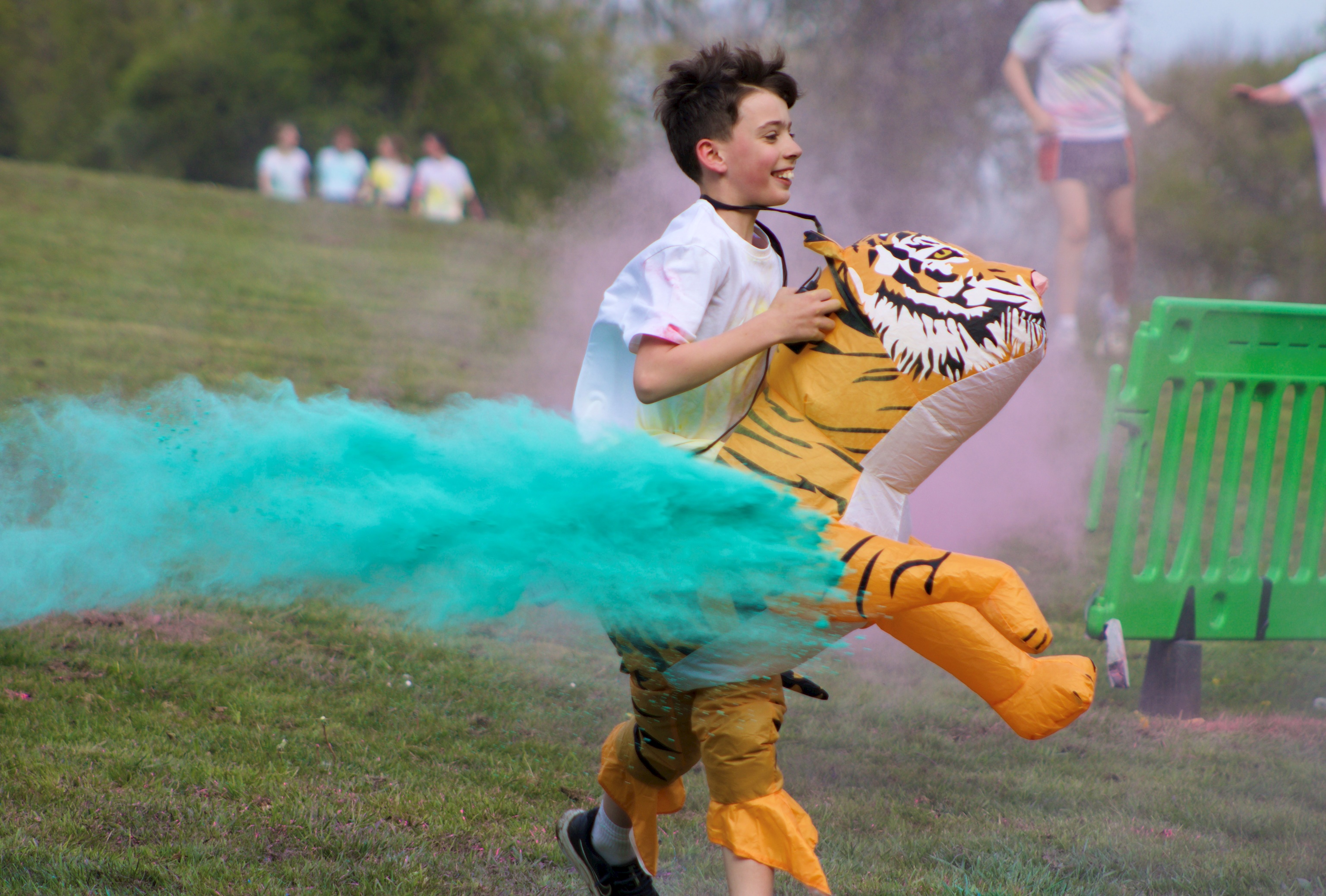 Pupils running with tiger custom in Colour Run 